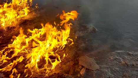 oil spill caught on fire, slowly burns and melts the surrounding snow