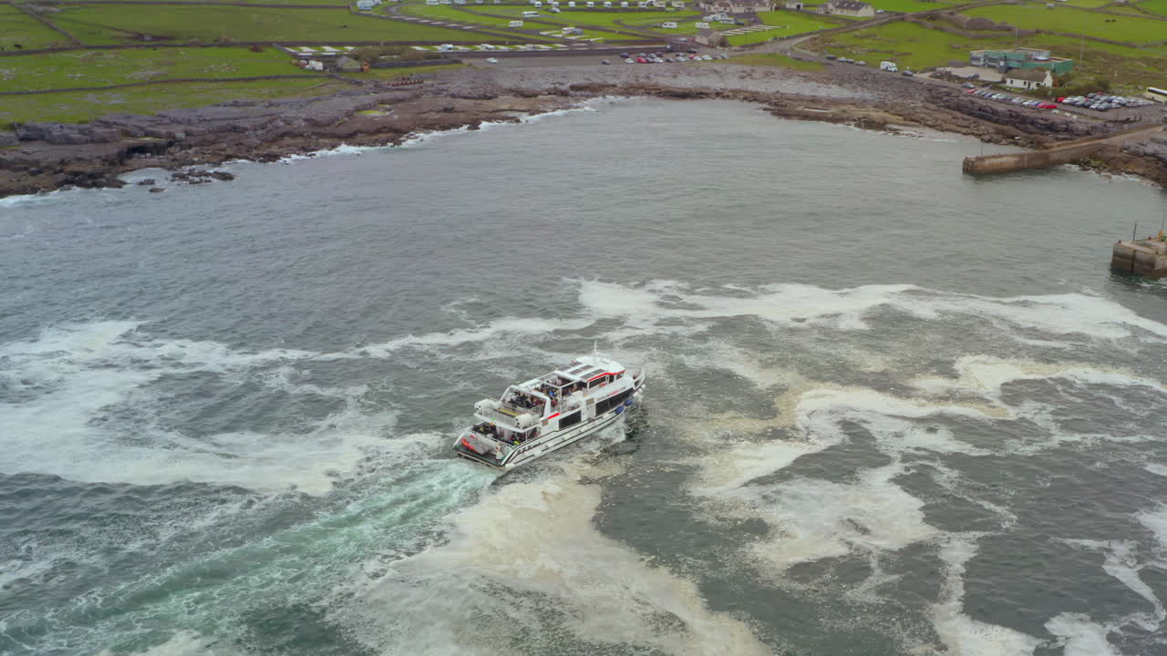 Bird’s-eye aerial tracks the Aran Islands ferry from above as it nears Doolin Pier on a rough Atlantic day