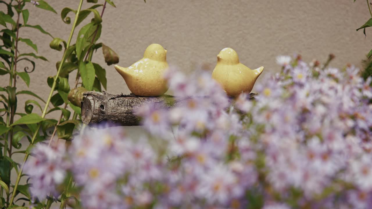 Cute Yellow Bird Figurines in a Garden Setting