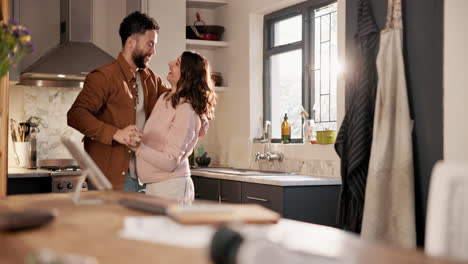 happy couple dancing in the kitchen