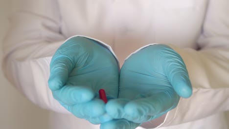 close-up pills fall into the gloved hands. close-up