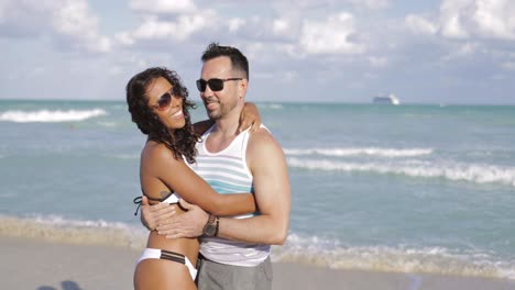 Beautiful-diverse-couple-embracing-on-beach