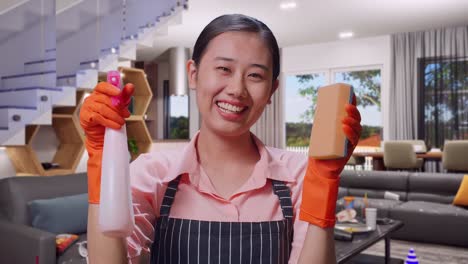 smiling woman cleaning a messy house