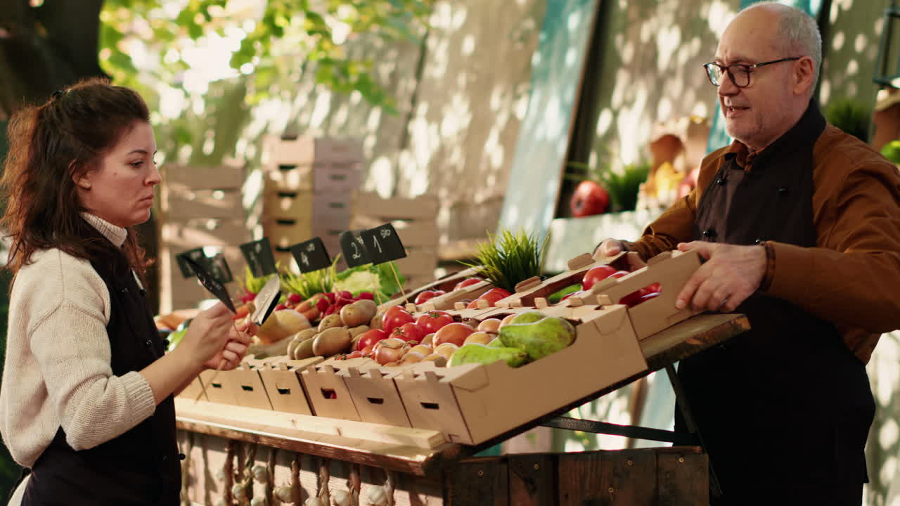 People at a local farmers market stand selling vegetables and fruit
