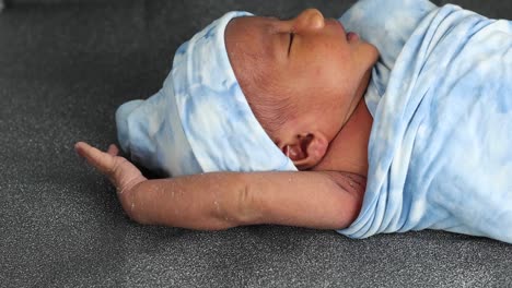 newborn baby wrapped on soft blanket