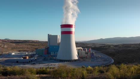 drone smoke steam from a coal fired power station plant blue sky sunset