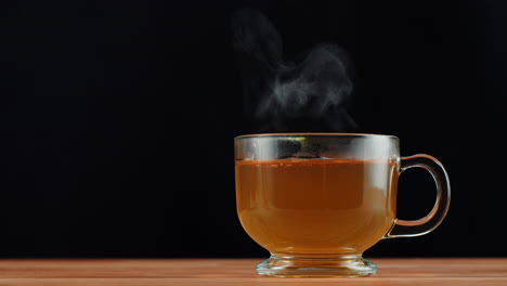 steaming hot tea in a clear glass cup