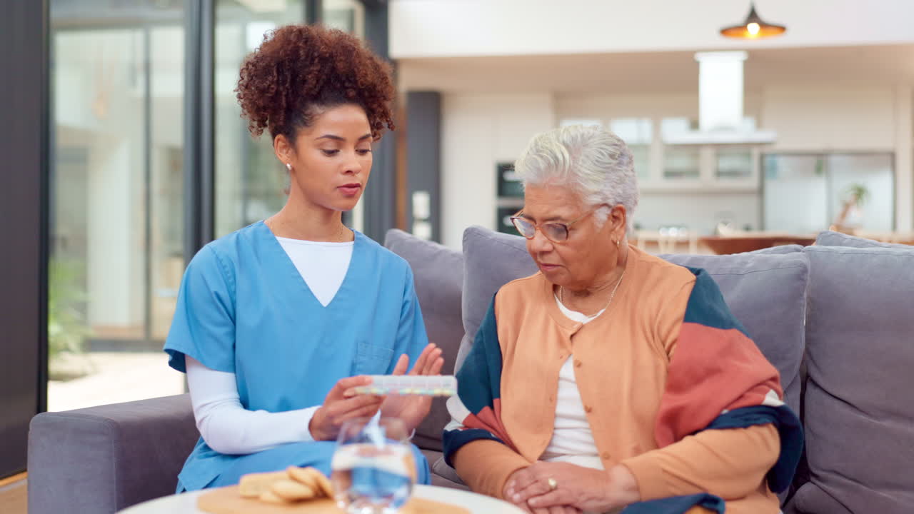 Nurse Discussing Medication with Elderly Patient at Home