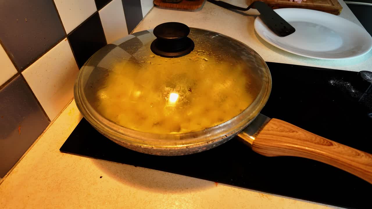 Timelapse of a man cooking a simple everyday meal at home - Potatoes, dumplings