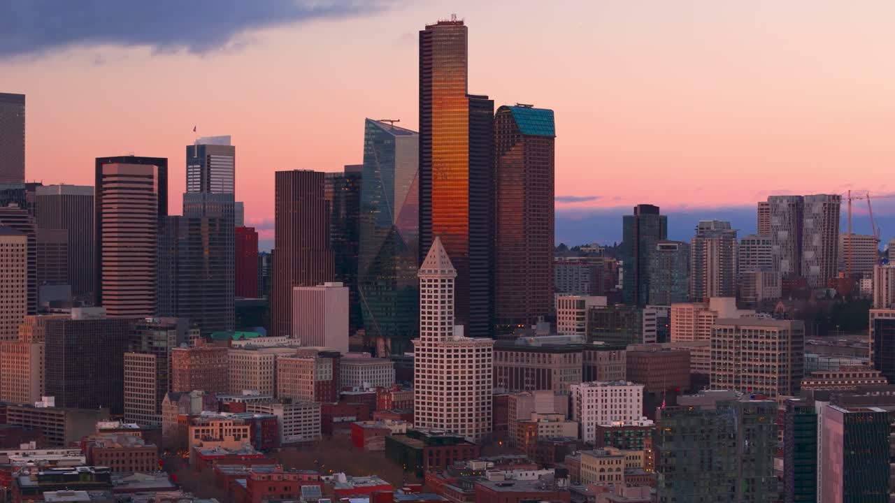 Seattle's Smith Tower surrounded by skyscrapers during sunset