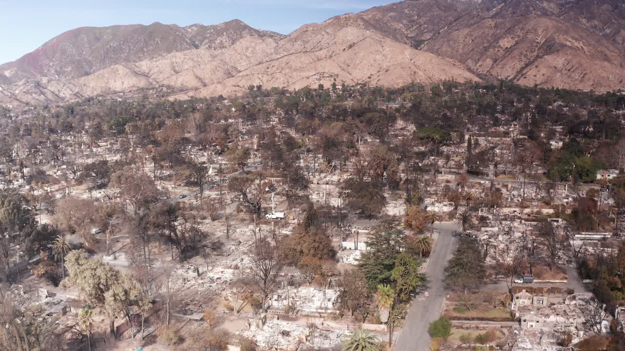 Aerial wide panning shot of the utter devastation within the Eaton Fire burn zone in Altadena, California. 4K