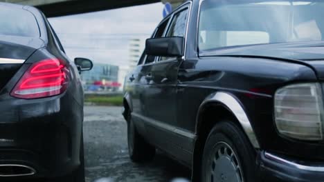 handing over something from one car to another on a street.