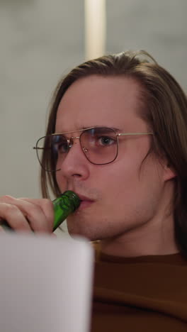 tense man with computer drinks beer and smiles of cool goal during football game at home closeup slow motion. victory of favorite team celebrating