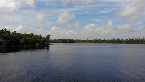 aerial of a beautiful lake with some reflection of the clouds
