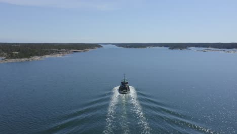 small tugboat making way ahead in finnish archipelago fairway