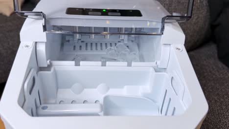 macro view of ice cubes forming on bullet mold heads inside a modern ice maker. clean, well-lit interior shot perfect for appliance demos, b-roll, and home tech explainer content