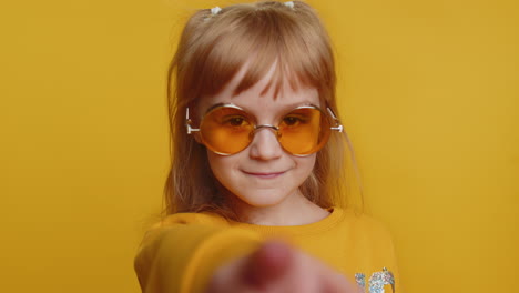 Child-girl-kid-smiling-excitedly-and-pointing-finger-to-camera,-choosing-lucky-winner,-indicating