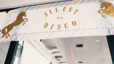 silent disco sign above the entrance of a party