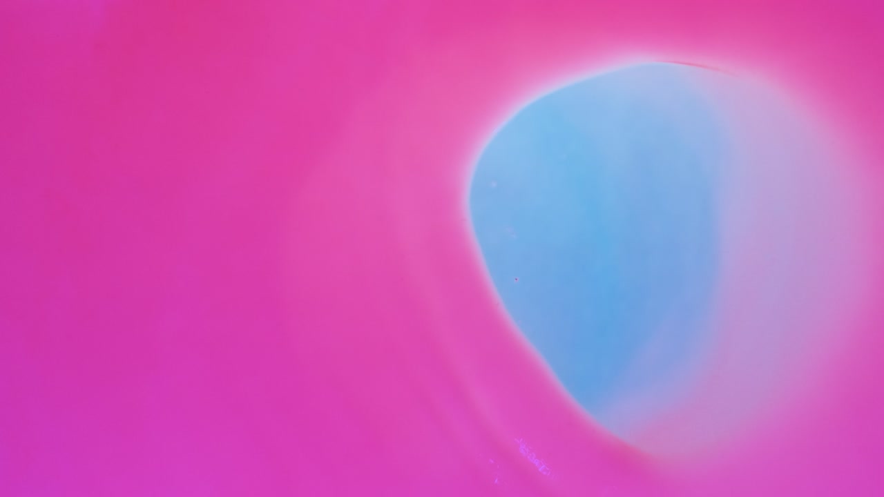Wind moves the circle of pink fluorescent paint horizontally.
