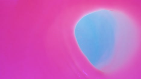 el viento mueve el círculo de pintura fluorescente rosa horizontalmente.