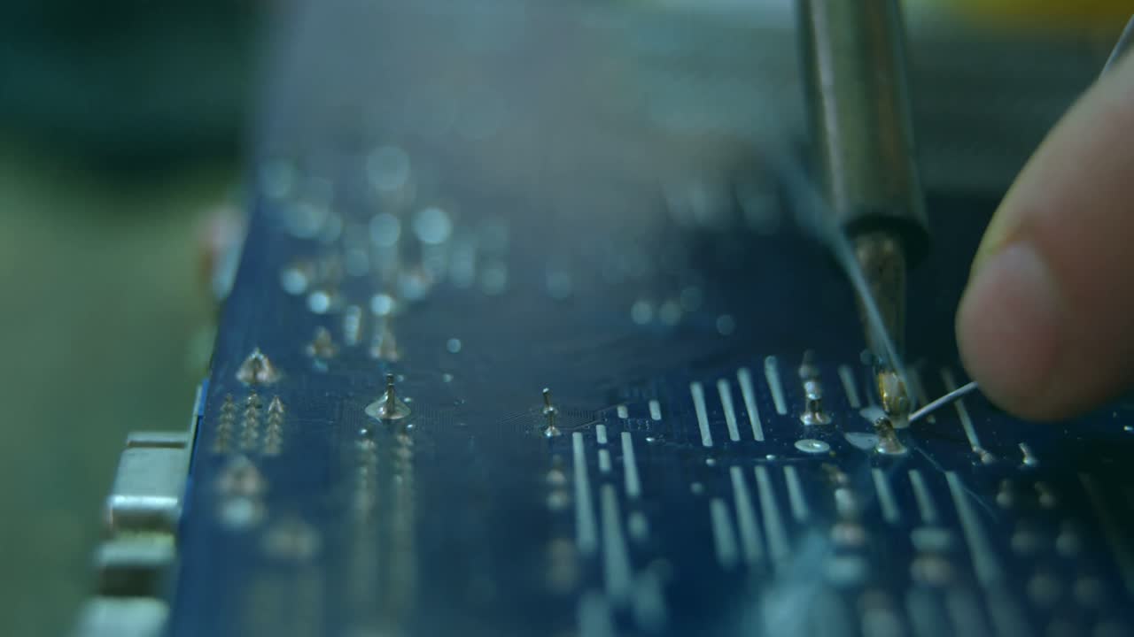 Close-up of robotic engineer assembling circuit board at desk 4k