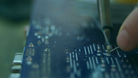 close-up of robotic engineer assembling circuit board at desk 4k