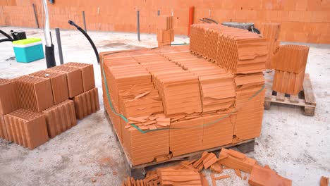 pallet of hollow ceramic bricks with corner damage at build site