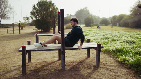 sun shines strongly on a man working out in the park