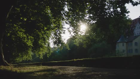 Person-Walking-in-Park-in-Tubingen,-Germany-in-4K-Downtown-Home-of-Europes-Oldest-University-At-Sunset