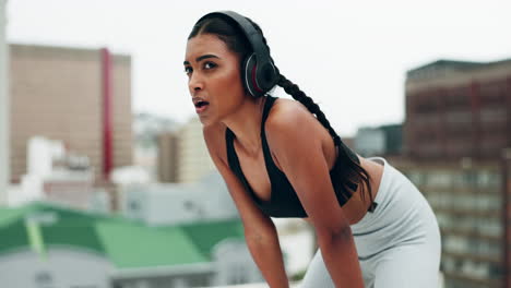 fitness, headphones and woman breathe in city