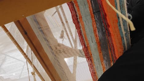 unique view from underneath a traditional loom in use