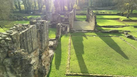 Basingwerk-abbey-landmark-medieval-abandoned-Welsh-ruins-Aerial-view-over-fly-closeup