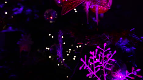 Christmas-tree-at-night-with-purple-lights---camera-moving-up