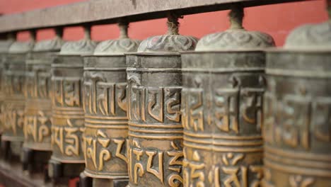 kathmandu nepal buddhist prayer wheels at monkey temple, close up of tibetan prayer wheels, used for prayer and praying in buddhism at a popular religious temple site and tourist attraction