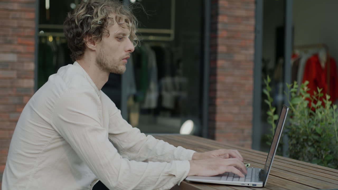 Man working on laptop outdoors