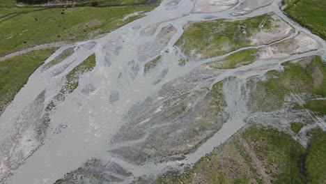 wide angle drone video of the beautiful mountains in northern italy with a giant waterfall and river. near the dolomites in south tyrol.