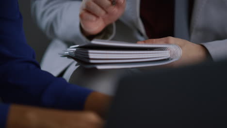 businessman hand writing notebook working at corporate meeting office workplace.