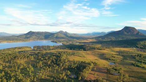 drone footage of mount edwards in queensland, australia with lake moogerah in the foreground in autumn