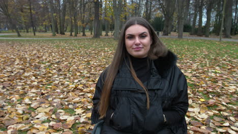 young beautiful woman on wheelchair in autumn park