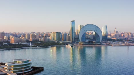 Sunset-panorama-of-Baku-urban-skyline-reflected-in-Caspian-bay,-Azerbaijan