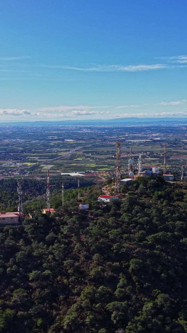 Vista de colinas verdes y ciudad distante desde un punto elevado en España
