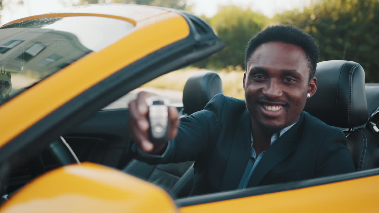 노란색 컨버터블을 운전하는 남자