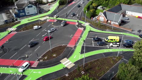 Aerial-view-vehicles-travelling-St-Helens-CYCLOPS-traffic-optimisation-junction-crossroad-intersection,-Panning-right-shot