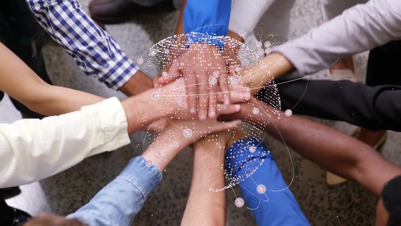 Hands reaching in, team stacking hands and pressing while globe particles orbit, lifting for unity