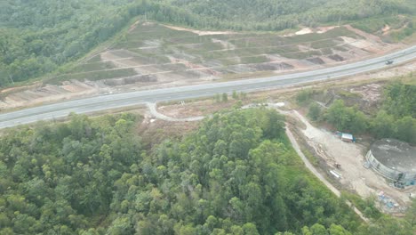 beautiful drone view of bau to lundu pan borneo highway during morning sunset with mountain and valley, green forest,sarawak, borneo.