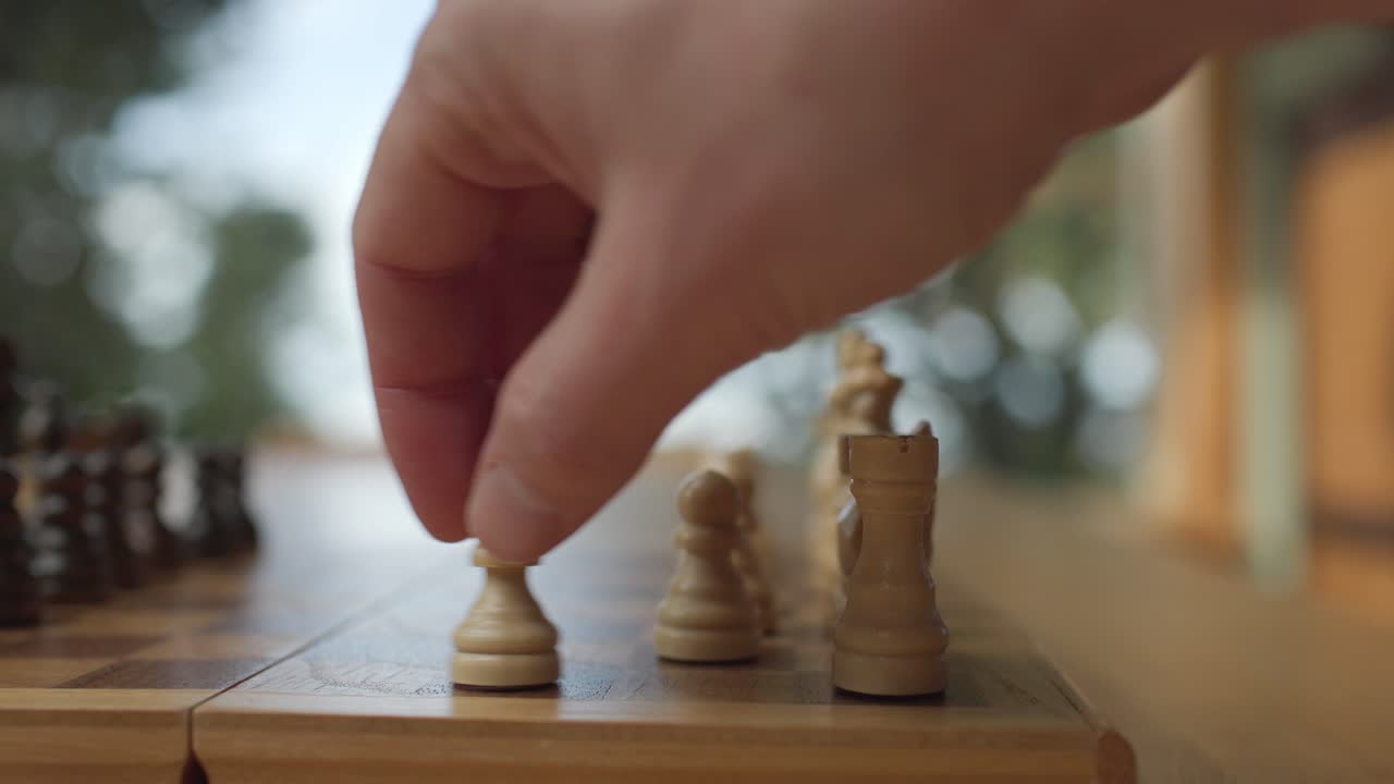 Hand Moving Chess Piece On Board - Close Up