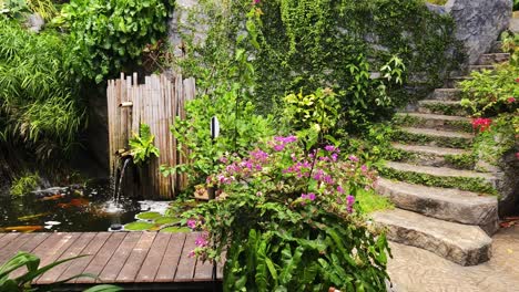 tropical garden with water feature and stone steps