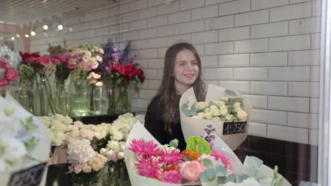 woman choosing beautiful and colorful bouquets of flowers in a charming flower shop a woman admires beautiful flower bouquets in a vibrant shop exploring her wonderful options and selections