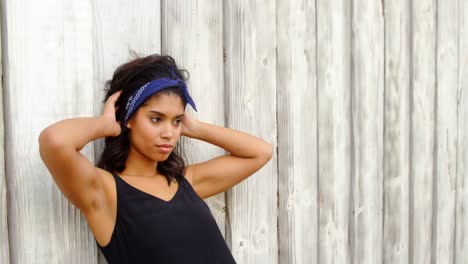 woman leaning on wooden wall 4k