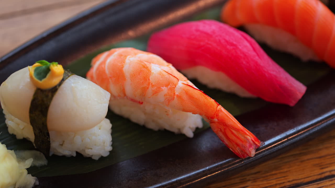 Close up of multiple nigiri on a black tray at a restaurant